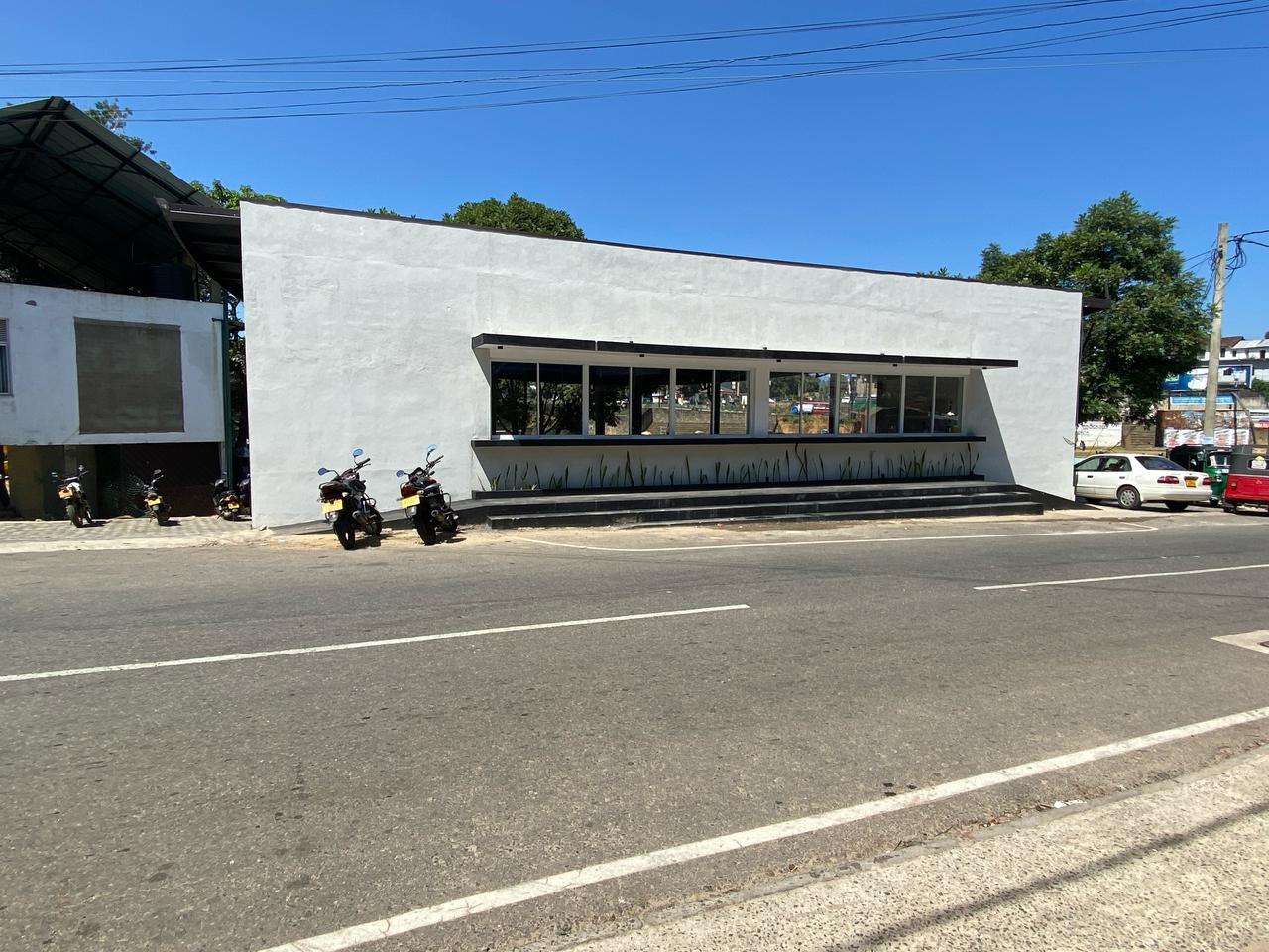 Modern glass-fronted commercial building on a main road in Bandarawela